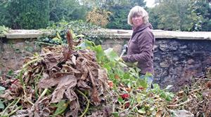 Jane Moore turning the compost